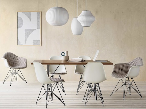 Eames Molded Fiberglass Chairs in parchment with checker sienna dark khaki upholstery and seat pads around Nelson X-leg table in santos palisander.