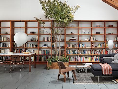 Eames Moulded Plywood Chairs with wood legs and chrome-plated legs.