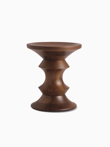 An A-shaped Eames Turned Stool in walnut.