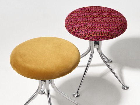 A pair of Girard Stools upholstered in textiles.