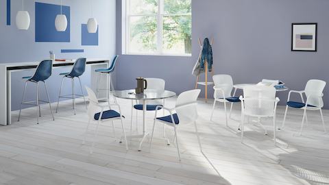 Two round tables surrounded by three white Keyn side chairs in a cafe space.