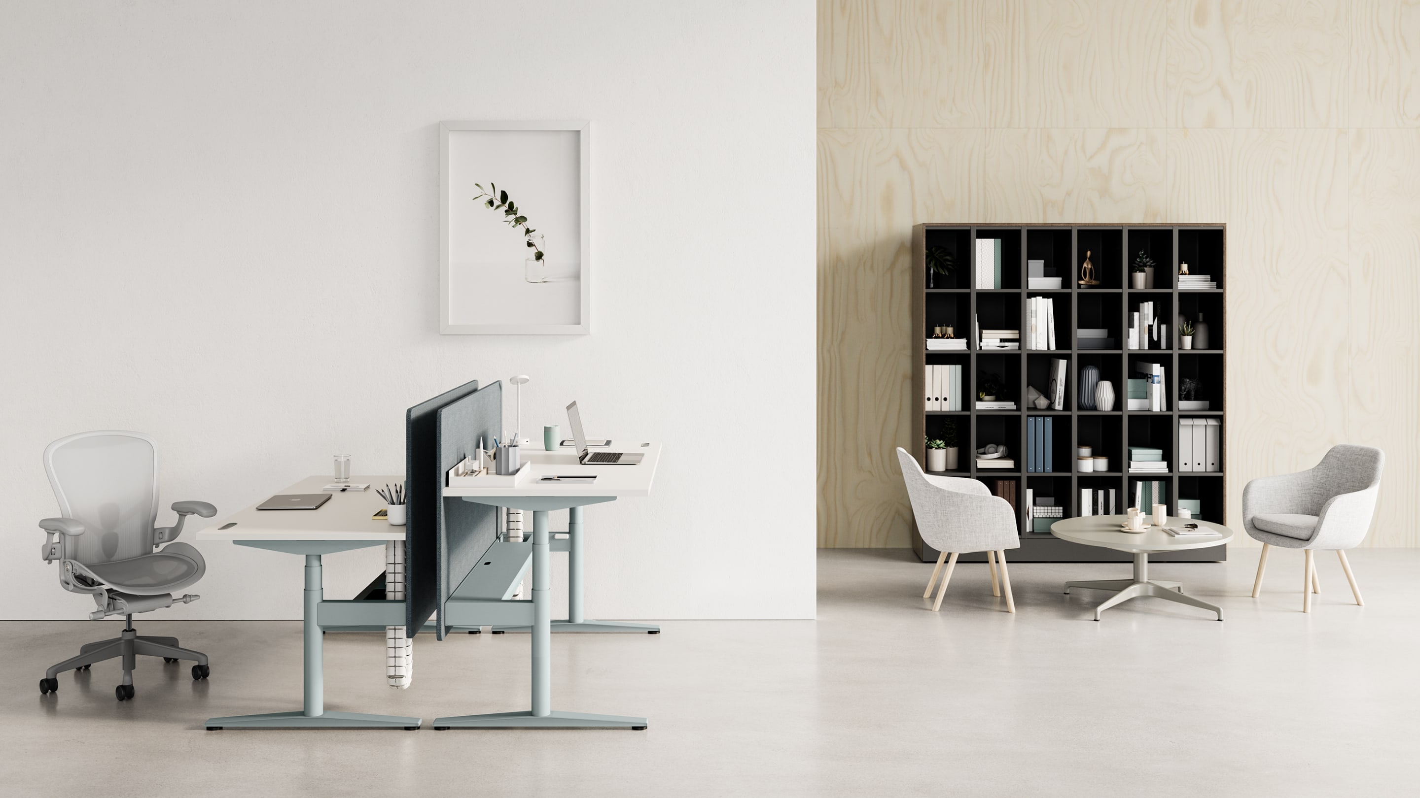 A back-to-back Ratio desk at both standing and seated heights with a light-grey Aeron Chair. Two grey Saiba Chairs with an occasional-height Civic Table are shown in front of a Port Storage System.