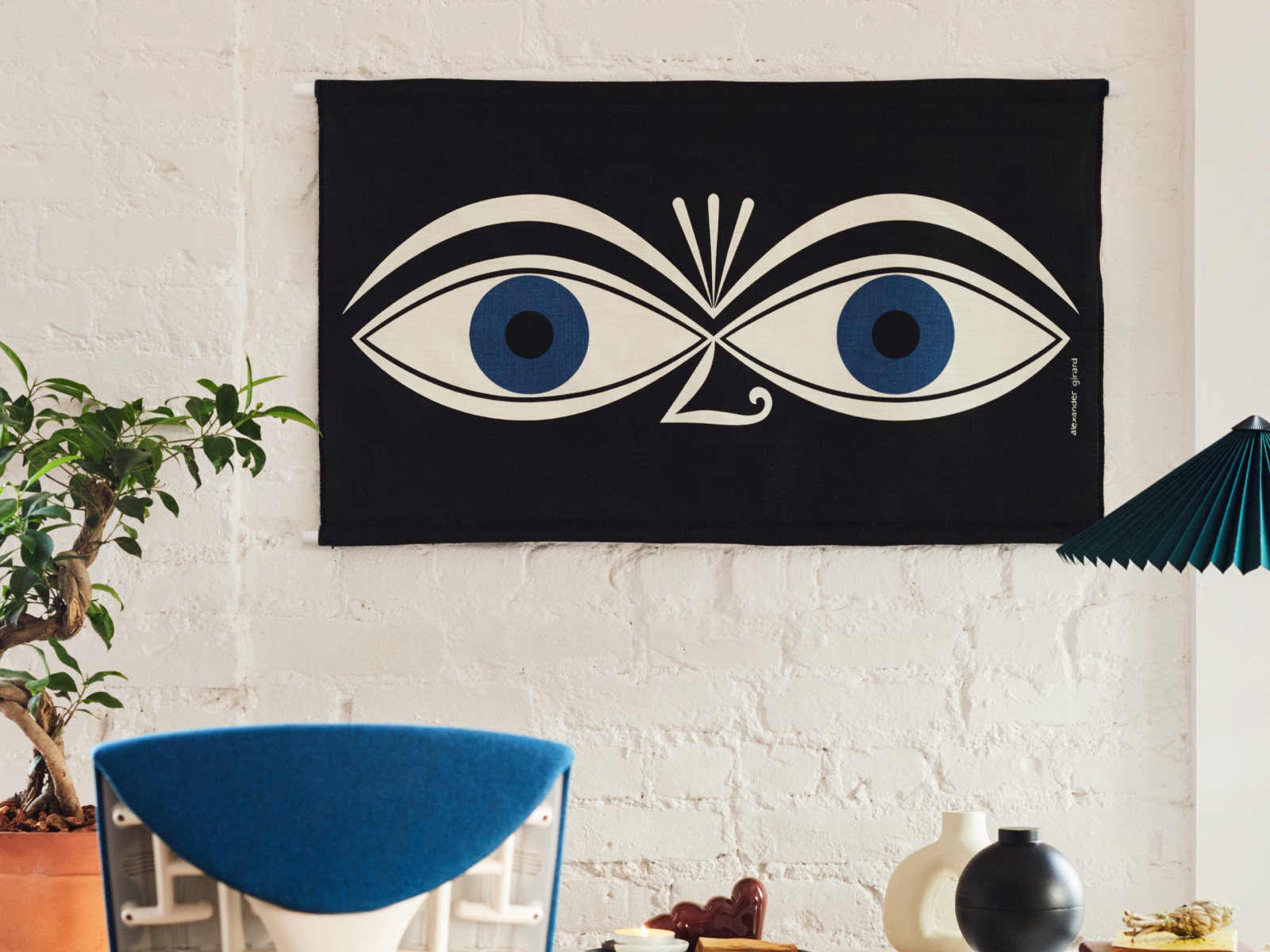 A Girard Environmental Enrichment Panel in Eyes pattern hanging on a wall.
