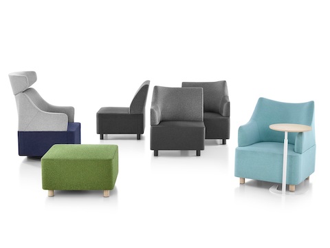 A collection of Plex seating elements, including grey modular components, blue club chairs and a green ottoman.