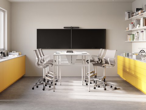 Six Setu Stools surround a table in a collaborative workspace.