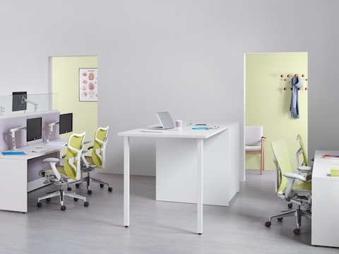 A healthcare administrative area equipped with benching work areas, green Mirra 2 Chairs and a standing-height collaboration surface.