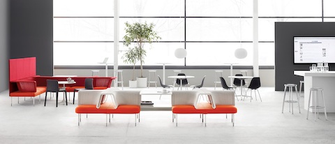 An open collaboration area featuring Social Chairs from the Public Office Landscape system in orange, red and white.