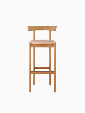 An oak bar-height Comma Stool with a seat pad, viewed from the front.