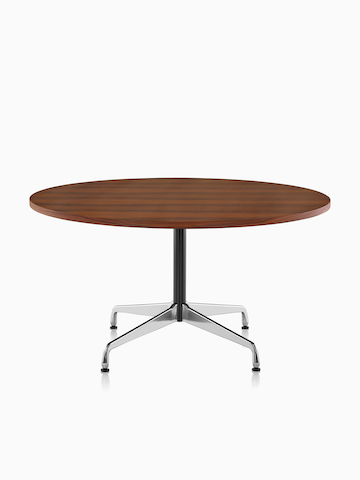 A round Eames Table with a dark veneer top.
