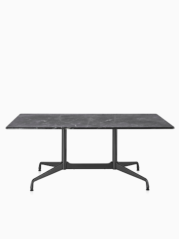 A rectangular Eames outdoor table with a black stone top.