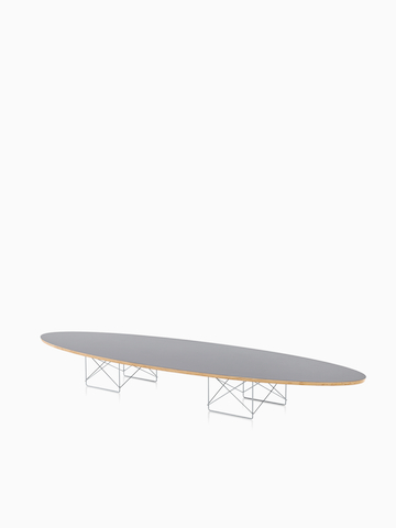 An Eames Wire Base Elliptical Table with a gray top. Select to go to the Eames Wire Base Elliptical Table product page. 