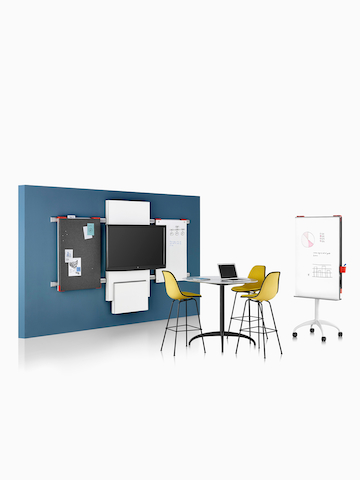 A study area featuring Exclave collaboration elements and Eames Moulded Plastic Stools.