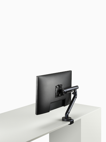 Flo Single monitor arm in black viewed at an angle.