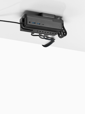 Loop Micro Mount attached under a desk cradling a thin client or power docking station with attached cables that are routed tidily to the edge and above the desk.