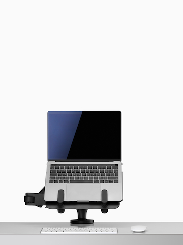 Front view of an open laptop raised and supported by an Ollin Laptop and Tablet Mount connected to an Ollin Monitor Arm.