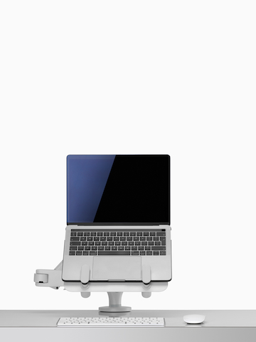 Front view of an open laptop raised and supported by an Ollin Laptop and Tablet Mount connected to an Ollin Monitor Arm. Select to go to the Ollin Laptop and Tablet Mount product page.