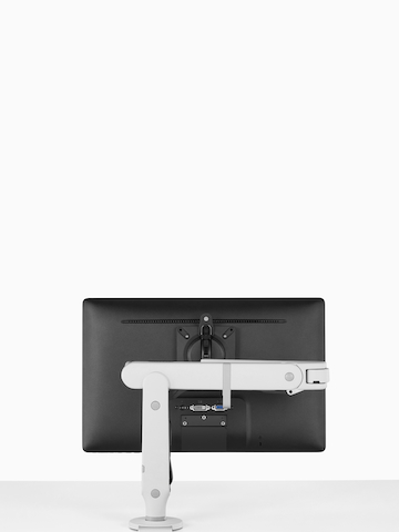 An adjustable Ollin Monitor Arm attached to a work surface. Select to go to the Ollin Monitor Arms product page.