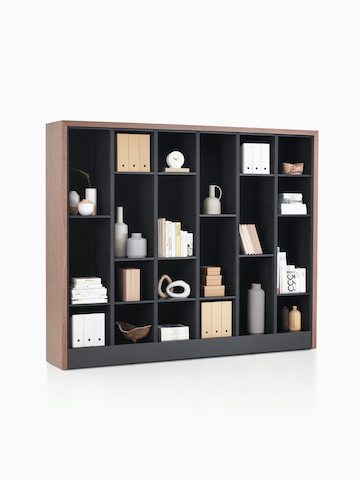 Port Storage System with a wooden frame and black shelves being used as a decorating cabinet.